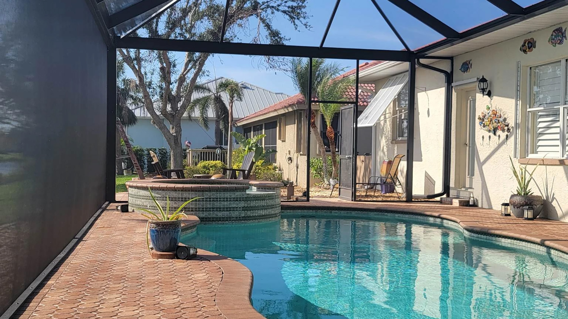 A large screened enclosure above an ingound pool